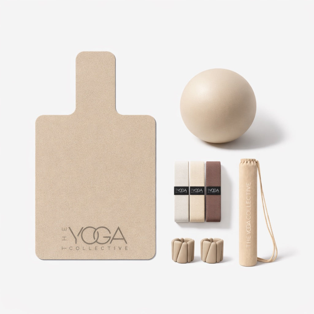 Collection of pilates accessories including a reformer mat, ball, wrist weights, bag and straps on a white background.